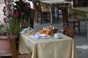 a table with a plate of food on it at Tassos Rooms in Kórinthos