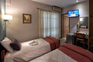 Posteľ alebo postele v izbe v ubytovaní Tassos Rooms