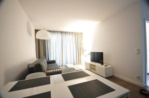 En eller flere senge i et værelse på Apartament Bel Mare Pelikan