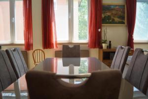 a table and chairs in a room with red curtains at Mamini's Apartment in Budapest