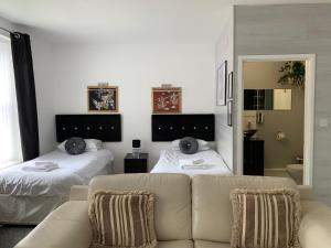 a living room with two beds and a couch at Boars Head Boutique Hotel in Sunderland