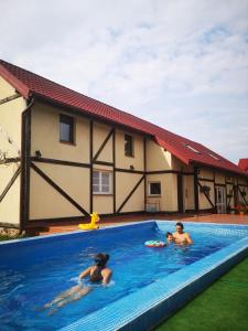a group of people swimming in a swimming pool at Nawiady 18A in Piecki