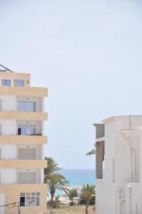 a view of a building and the ocean at Apartment zone touristique 80 m beach free wifi in Mahdia