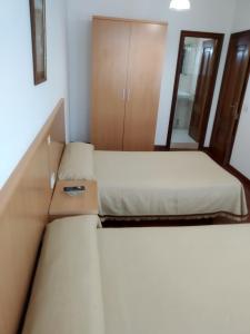 Postel nebo postele na pokoji v ubytování HOSTAL RESIDENCIA PRESIDENTE