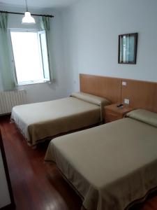 Postel nebo postele na pokoji v ubytování HOSTAL RESIDENCIA PRESIDENTE