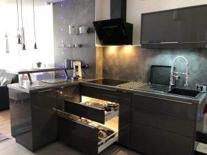 a kitchen with a sink and a counter with an open drawer at Dieppe centre historique proche château et plage in Dieppe