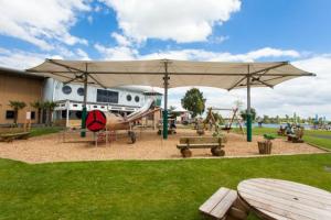a playground with an airplane and a park with benches at The Salsa Attractive accomodation at Tattershall Lakes in Tattershall