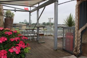 a patio with tables and chairs and pink flowers at Boars Head Boutique Hotel in Sunderland