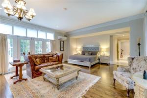 a living room with a couch and a bed at Greenview Manor, Luxury Bed & Breakfast in Niagara-on-the-Lake
