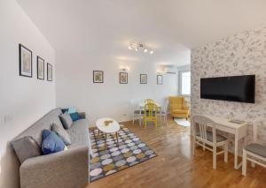a living room with a couch and a table at Apartman Osijek in Osijek