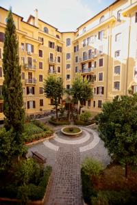 a courtyard with a fountain in front of a building at Residenza Mazzini in Rome