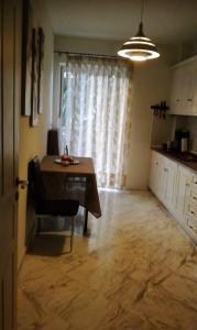 a dining room with a table and a kitchen at Sea View Apartment in Chalkida