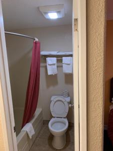 a small bathroom with a toilet and a shower at A-1 Budget Motel in Klamath Falls