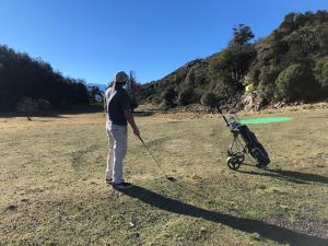 a woman with a stick and a baby stroller at Patagonia Acres Lodge in Mallin Grande