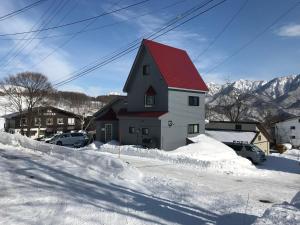 長野市にあるSunnsnow Tall houseの雪の赤い屋根の家