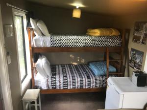 a bedroom with a bunk bed and a desk at Sandy Feet Accommodation in Christchurch