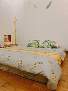 a bedroom with two beds with a blanket on it at Cozy Private Home @ HCM D.5 in Ho Chi Minh City