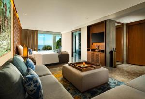 a living room with a couch and a bed at Anantara Uluwatu Bali Resort in Uluwatu