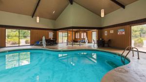 a large swimming pool in a large room with a large at SureStay Plus Hotel by Best Western Black River Falls in Black River Falls