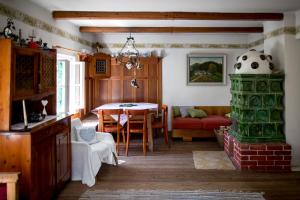 a living room with a table and a fireplace at Roatmoaralm Almhütte in Rachau