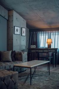 a living room with a couch and a table at node hotel a Member of Design Hotels in Kyoto