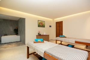 a room with two beds and a sink at Anja Jimbaran in Jimbaran
