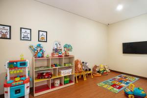 a room with a tv and toys in it at Anja Jimbaran in Jimbaran