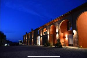 a building with arches on the side of it at Agriturismo Mascudiera in Fiorenzuola dʼArda