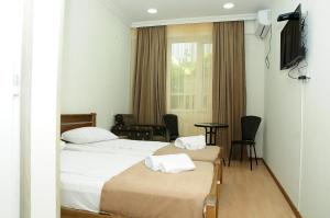 Voodi või voodid majutusasutuse Family Hotel Chino toas