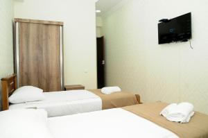 Voodi või voodid majutusasutuse Family Hotel Chino toas