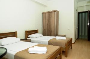 Voodi või voodid majutusasutuse Family Hotel Chino toas