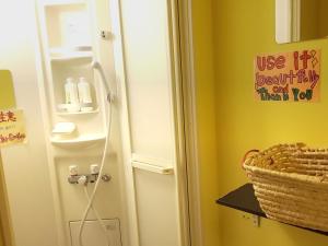 a bathroom with a white door and a basket at Fukuoka Guesthouse Little Asia Kokura in Kitakyushu +48 photos