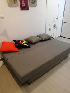 a bed with two pillows on it in a room at Apartamentos Playa Benitez in Ceuta