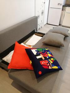 a bed with two pillows on top of it at Apartamentos Playa Benitez in Ceuta