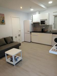 a living room with a couch and a table at Apartamentos Playa Benitez in Ceuta