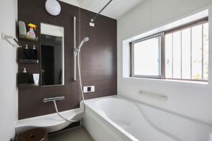 baño con bañera y ventana en Hotel EL Shinjuku 1 free parking, en Tokio