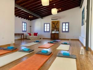 a yoga class in a large room with yoga mats at Cyprus Villages Hotel & Restaurant - Central Location - Bed & Breakfast - With Access To Pool And Stunning Views in Tochni