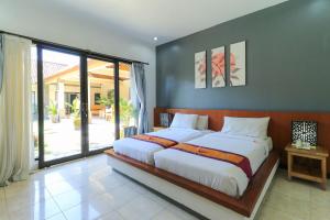 Säng eller sängar i ett rum på Bali Merita Villa