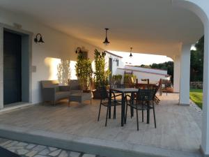 a patio with a table and chairs on it at LU ANTU alloggi agrituristici in Arzachena