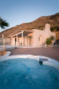 a swimming pool in front of a house at Villa Achilleas Crete in Ierápetra