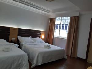 Katil atau katil-katil dalam bilik di Sara Hotel