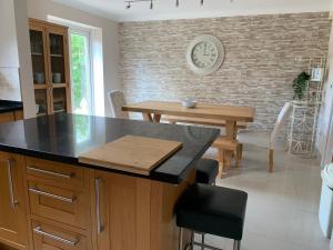 a kitchen with a table and a dining room at Thorn House a beautiful large house in Witney in Witney