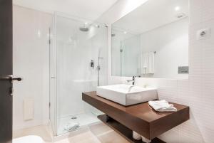 a bathroom with a sink and a shower at Laguna - Vilamoura in Vilamoura