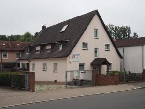 a large white house with a black roof at Ferienwohnung Franken in Fürth