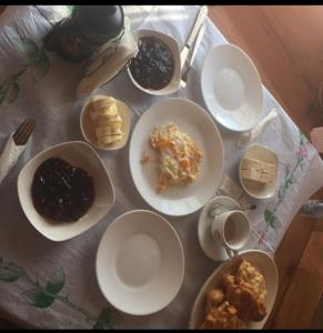 une table avec des assiettes et des bols de nourriture dans l'établissement Guest House Genti, à Berat