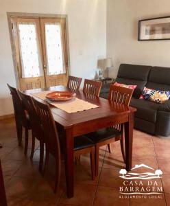 a dining room table with chairs and a pizza on it at Casa da Barragem in Montalegre
