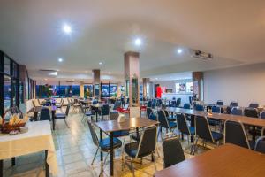 a dining room with tables and chairs and tablesktop at The Train Hotel Hatyai in Hat Yai