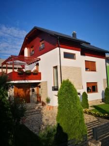 a house with a red and white at Accommodation Plitvice in Korenica