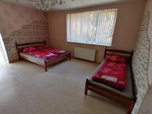 a bedroom with two beds and a window at Kempings "Ceļmalnieki" in Liepāja