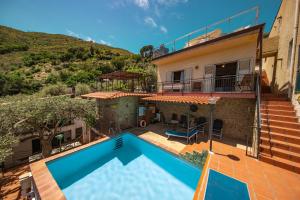 an image of a swimming pool in a house at L' Arca Residence in Cefalù